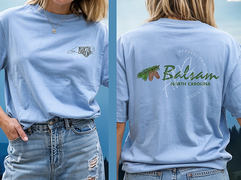 Light blue t-shirt with 'Balsam North Carolina' design on the back, worn by a person.